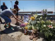  ?? AP/ANDRES LEIGHTON ?? Residents of El Paso, Texas, place flowers at a makeshift memorial Sunday for victims of Saturday’s mass shooting at a shopping complex in the city.