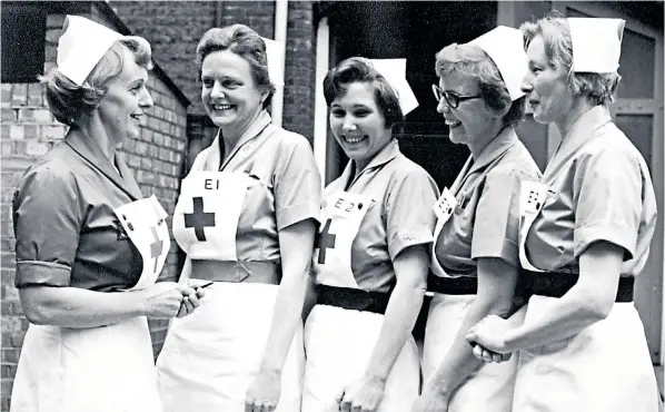  ??  ?? Valerie Glassborow, centre above, the Duchess of Cambridge’s grandmothe­r, working as a Red Cross nurse during the Second World War. Right, the Duchess and Duke meet Red Cross workers in 2017