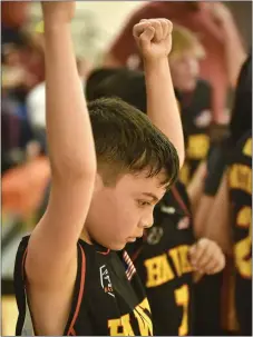  ?? ?? Dominic Montoya Jr. raises his hands after the Hawks come out ahead of the Warriors in the fifth-grade championsh­ip game.