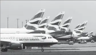  ?? CHRIS RATCLIFFE / BLOOMBERG ?? A passenger airplane operated by British Airways taxis at London Heathrow Airport in the United Kingdom in March.