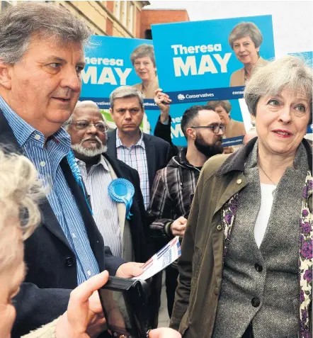  ??  ?? Theresa May, pictured on the campaign trail this week, has a team working under tight security to finalise the Tory manifesto amid soaring popularity