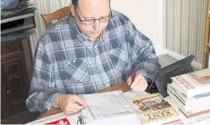  ??  ?? David Wood pours over some documents