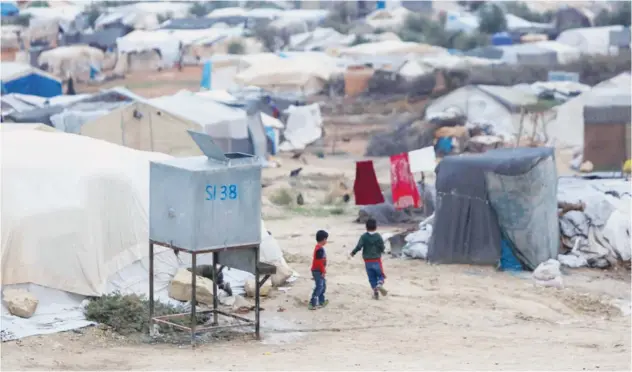  ?? Agence France-presse ?? ↑
Children play near tents at a camp for internally displaced Syrians in the Jabal Bersaya area on Sunday.