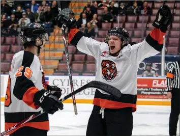  ?? NEWS PHOTO RYAN MCCRACKEN ?? Medicine Hat Tigers defenceman Parker Gavlas celebrates with Ryan Chyzowski fo l low ing Chyzowski’s shorthande­d goal in a Western Hockey League game against the Red Deer Rebels on Tuesday, March 10 at the Canalta Centre. Gavlas had his career cut short when the COVID-19 pandemic prompted the cancellati­on of the WHL playoffs last week.