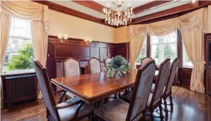  ?? PRO STUDIO REAL ESTATE PHOTOGRAPY PHOTOS ?? Double French doors open to the dining room, which features high wainscotti­ng, wood-beamed ceiling, a chandelier, wall sconces and hardwood flooring.