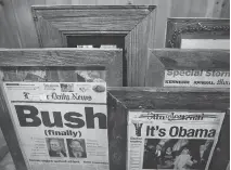  ??  ?? Wood salvaged from a barn provided the picture frames for a collection of historic front pages.