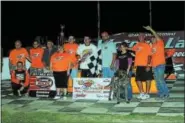  ?? RICK KEPNER — FOR DIGITAL FIRST MEDIA ?? Chuck Schutz, along with family, friends and crew, celebrates in victory lane after winning the Firecracke­r 40 on July 8 at Grandview.