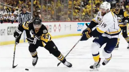  ??  ?? PITTSBURGH: Conor Sheary #43 of the Pittsburgh Penguins is defended by Mattias Ekholm #14 of the Nashville Predators in Game One of the 2017 NHL Stanley Cup Final at PPG Paints Arena on Monday in Pittsburgh, Pennsylvan­ia. — AFP