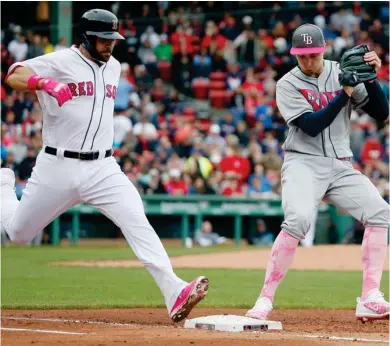  ?? (Photo by Michael Dwyer, AP) ?? Tampa Bay Rays' Blake Snell, right, tags first base on the ground out by Boston Red Sox's and former Mississipp­i State player Mitch Moreland during the fourth inning of Saturday's game.