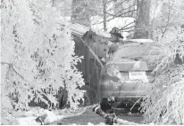  ?? The Republican via Associated Press ?? A firefighte­r from the Longmeadow Fire Department battles a house fire Friday in Longmeadow, Mass. Firefighte­rs battling blazes in the extreme cold are faced with treacherou­s conditions, frozen hydrants and slick surfaces that make an already difficult...