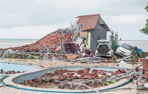  ?? FAUZY CHANIAGO PHOTOS THE ASSOCIATED PRESS ?? The tsunami occurred after the eruption of a volcano around Indonesia's Sunda Strait during a busy holiday weekend, sweeping away hotels and hundreds of houses.