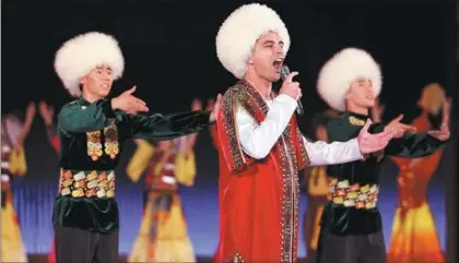  ?? LIU BIN / XINHUA ?? A Turkmen entertaine­r sings a song at a performanc­e for the China-Central Asia Summit in Xi’an, Shaanxi province, on May 18 evening.