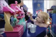  ?? AP PHOTO/RICHARD DREW ?? In this Aug. 30, 2018, photo 20-month-old Eva plays with Num Nom Silly Shakers Maker toy at the Walmart Toy Shop event in New York. Walmart says 30percent of its holiday toy assortment will be new. It will also offer 40percent more toys on Walmart.com from a year ago. In November and December, the company’s toy area will be rebranded as “America’s Best Toy Shop.”