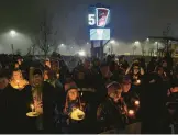  ?? JOSHUA BESSEX/AP ?? Bills fans and community members gather for a candleligh­t vigil for Bills safety Damar Hamlin on Tuesday in Orchard Park, N.Y.