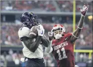  ?? TONY GUTIERREZ — THE ASSOCIATED PRESS ?? TCU wide receiver Jalen Reagor, here hauling in a touchdown over Oklahoma cornerback Parnell Motley in the 2017 Big 12 championsh­ip game, will start life with the Eagles as DeSean Jackson’s backup and heir apparent.