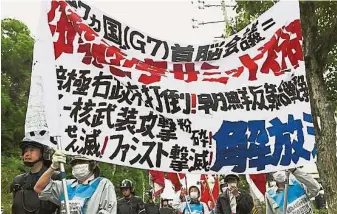  ??  ?? 七國集團（G7）峰會周三在日本三重縣­伊勢志摩市召開，約28名反G7示威者­高舉橫幅在會場外抗議。（法新社照片）