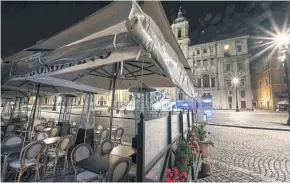  ??  ?? NO MAN’S LAND: A deserted restaurant terrace at Piazza Navona in central Rome last Thursday as Italy shut all stores except for pharmacies and food shops in a desperate bid to halt the virus spread.