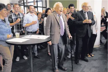  ?? Photos by Leah Millis / The Chronicle ?? S.F. Chronicle Science Editor David Perlman (center), at his retirement party, walks to the front of the room full of colleagues, friends and dignitarie­s as he is announced by Editor in Chief Audrey Cooper.