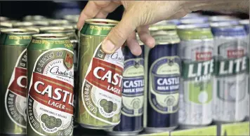  ?? PHOTO: BLOOMBERG ?? An employee restocks shelves with Castle beer, which is produced by SABMiller, at a Durban bottle store. SABMiller, having rejected four previous proposals, finally relented when Anheuser-Busch InBev agreed to increase the offer.