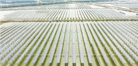  ?? Province. Photo: Xinhua ?? Aerial photo taken on November 5, 2020 shows photovolta­ic solar panels in Sheyanghu Township of Baoying County, east China’s Jiangsu