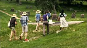  ?? Audrey Medrano ?? Lena Chen, artist and then-MFA candidate at Carnegie Mellon University, leads a walking tour of Homewood Cemetery’s Chinese section on May 21. The tour is part of a series of events organized by Jaded.