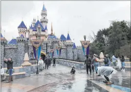  ?? Amy Taxin The Associated Press ?? California officials will allow people to go to Disneyland, attend sporting events and watch live performanc­es at outdoor venues in limited capacities starting April 1.