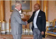  ?? Photo — AFP ?? King Charles III shakes hands with Alexander Williams, the High Commission­er of Jamaica, during an audience at Buckingham Palace in London.