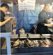  ?? PETER ROBB/OTTAWA CITIZEN ?? Fish grills at the Richmond Night Market, at B.C.’s Magical Duck Island.