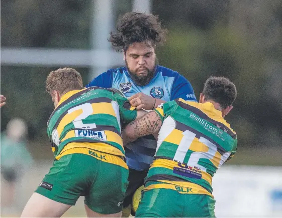  ?? Picture: JERAD WILLIAMS ?? Helensvale's Vernon Isaacs gets hit by Surfers defenders and has a bad hair moment in the same experience.