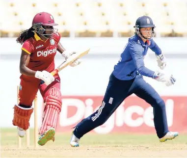  ?? WICB MEDIA/ATHELSTAN BELLAMY ?? West Indies’ Stafanie Taylor takes a run as England’s wicketkeep­er Amy Jones chases the ball during the second one-day internatio­nal between West Indies Women and England Women at the Trelawny Multiplex in Florence Hall, Jamaica, yesterday.