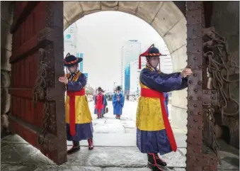  ?? YONHAP ?? Traditiona­l Korean attire is on show in Seoul on March 15 for a reenactmen­t of the opening of Sungnyemun, one of the four gates that surrounded the capital during the Joseon Dynasty (1392-1910).