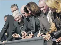  ?? Luis Sinco Los Angeles Times ?? GOV. Jerry Brown, center, at a bullet train station groundbrea­king. The rail project gets financing from cap-and-trade sales.