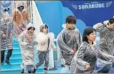  ??  ?? Participan­ts run during an antimissil­e evacuation drill at the Tokyo Dome City amusement park on Monday.
