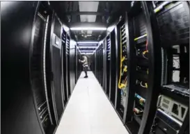  ?? YANG WENBIN / XINHUA ?? An employee checks on machines at a data center in Guiyang.