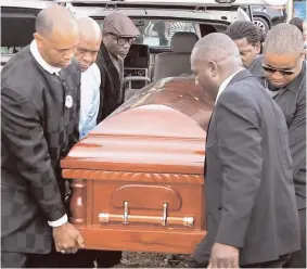  ?? CONTRIBUTE­D PHOTOS ?? Pall-bearers taking Fennell’s casket to his burial spot.