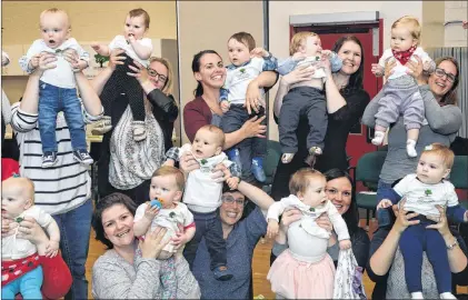  ?? JOE GIBBONS/THE TELEGRAM ?? Some of the mothers and their babies who participat­ed in this year’s Roots of Empathy “program “raise” their babies in a salute to the program. In celebratin­g 13 years in the Newfoundla­nd and Labrador English School District, a Roots of Empathy “baby...