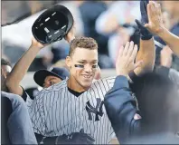  ?? AP PHOTO ?? In this May 2 file photo, teammates greet New York Yankees’ Aaron Judge in the dugout after he hit a solo home run during the third inning of a baseball game against the Toronto Blue Jays, in New York. This time last year, Judge had played exactly zero...