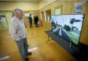  ?? MURRAY WILSON/STUFF ?? Alan Mccormack watches the new updated flyover video for the Manawatu¯ Gorge replacemen­t road.