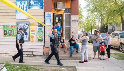  ?? TYLER PASCIAK LARIVIERE/SUN-TIMES ?? Chicago police work the scene Tuesday where five teens were shot, one fatally, in a drive-by in the 4800 block of South Ada Street.