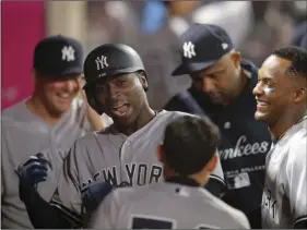  ?? AP PHOTO/JAE C. HONG ?? New York Yankees’ Didi Gregorius (second from left) celebrates his home run with teammates during the 10th inning of a baseball game against the Los Angeles Angels, on Friday, in Anaheim.