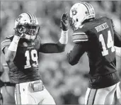  ?? KEVIN C. COX/GETTY ?? Nick Ruffin and Stephen Roberts celebrate a victory over Alabama, Auburn’s second No. 1 victim this season.