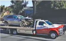  ?? AP PHOTO/ASHLEY LANDIS ?? A vehicle is towed away from the site of a crash involving golfer Tiger Woods in the Rancho Palos Verdes suburb of Los Angeles on Tuesday.