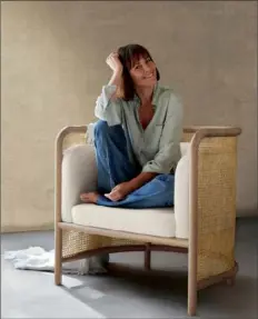  ??  ?? Leanne Ford sitting in her West cane chair for Crate & Barrel.