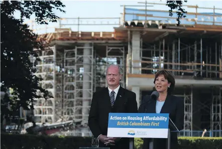  ?? — THE CANADIAN PRESS FILES ?? Premier Christy Clark, with Finance Minister Michael de Jong, defends the province’s new real estate tax on foreign nationals, saying her job is to ‘put British Columbians first.’
