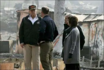  ?? EVAN VUCCI - THE ASSOCIATED PRESS ?? President Donald Trump talks with FEMA Administra­tor Brock Long, Jody Jones, Mayor of Paradise, and California Gov. Jerry Brown, second from right during a visit to a neighborho­od impacted by the wildfires, Saturday, Nov. 17, in Paradise, Calif.