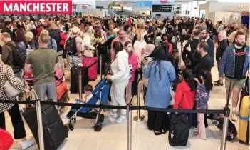  ?? ?? MANCHESTER
Grinding to a halt: Families wait in snaking queues to check in their luggage