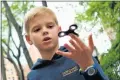  ?? Picture: AFP ?? TIME OUT: Louis Wuestenber­g, 10, plays with a fidget spinner in a park in New York