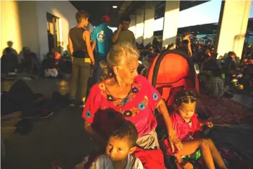  ?? — Washington Post photo ?? Amanda Breve Jimenez, 73, rests with her grandchild­ren in Juchitan. Four of her 10 children in Honduras had been killed. Five had already fled the country. She hoped to join four of them in the United States.