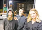  ?? ELIZABETH ROBERTSON/ PHILADELPH­IA INQUIRER ?? Johnny Bobbitt
Jr., left, Kate McClure, right, and Mark D’Amico pose at a Citgo station were they claimed Bobbitt purchased gas for McClure’s stranded car.