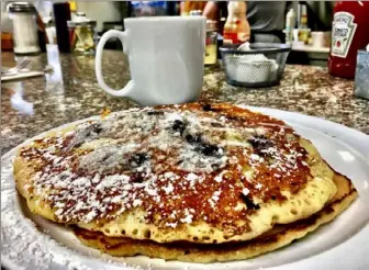  ?? Dan Gigler/ Post- Gazette ?? A plate of blueberry pancakes at Eggs & Moore in Arlington.